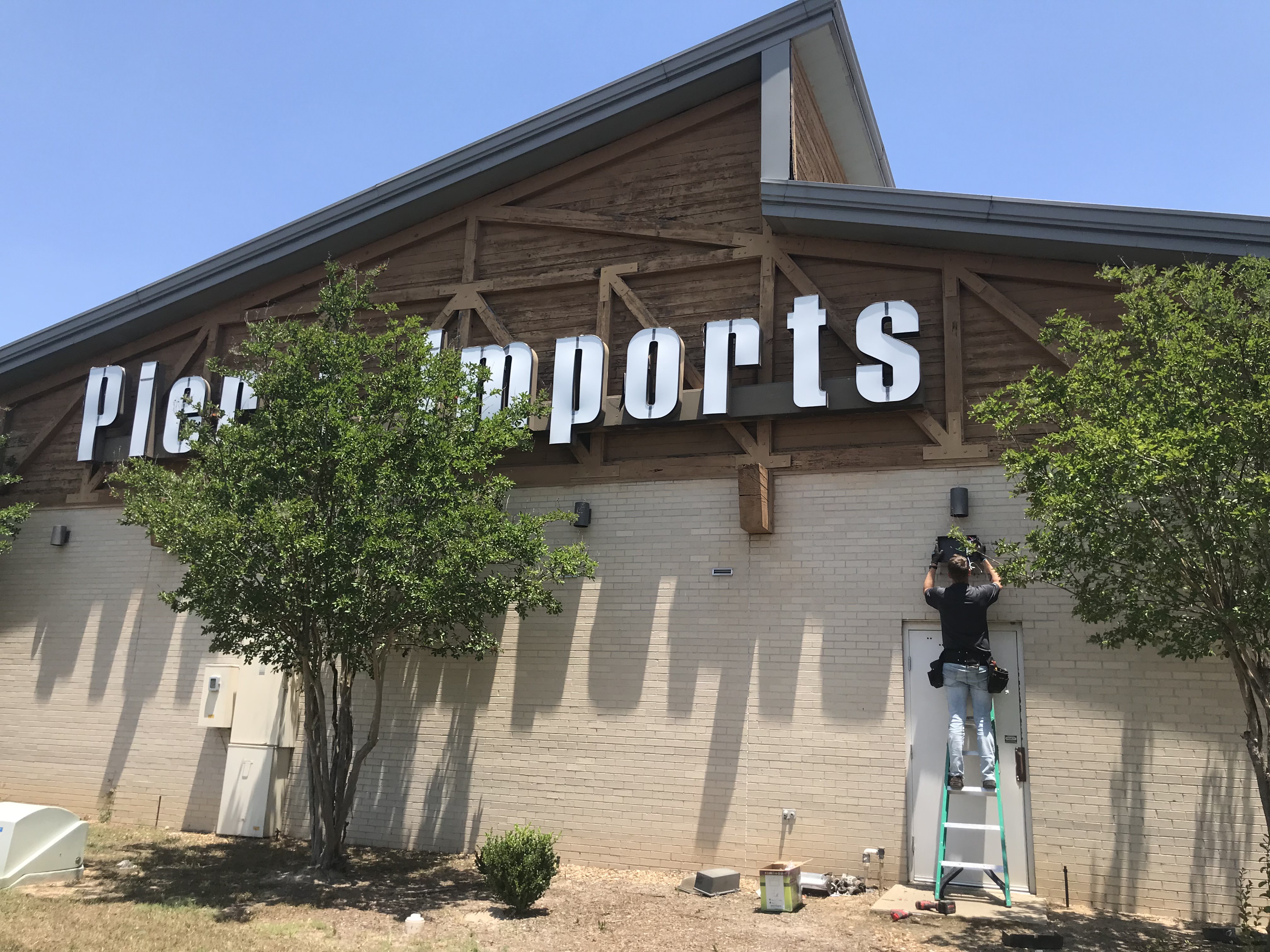 Drop Line Electric commercial electrician installing exterior lighting at Pier 1 Imports in Monroe, LA