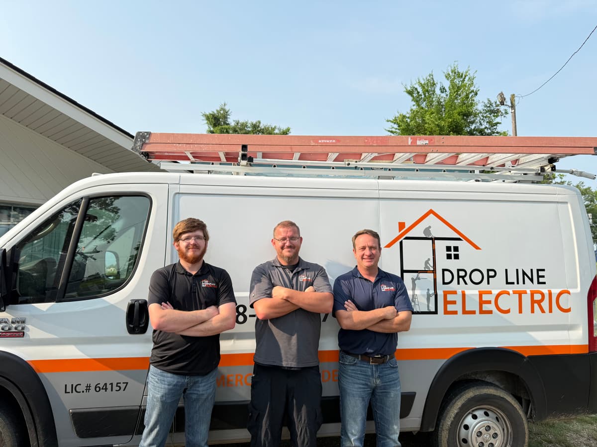 Drop Line Electric Team - Professional electricians standing in front of company van